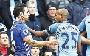  ?? PAUL ELLIS/AFP ?? Manchester City midfielder Fernandinh­o (right) grabs Chelsea’s Cesc Fabregas in their English Premier League match at the Etihad Stadium on December 3.