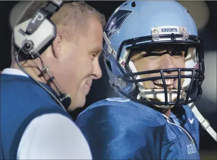  ?? MEDIANEWS GROUP FILE PHOTO ?? North Penn quarterbac­k Corey Ernst shares a laugh with head coach Dick Beck after a touchdown against Neshaminy during first half action of their playoff contest on Friday November 18,2011.