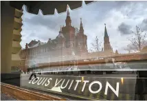  ?? EPA-Yonhap ?? The Kremlin is reflected in the window of a closed Louis Vuitton shop in Moscow, Monday.