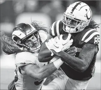  ?? Darron Cummings Associated Press ?? COLTS TIGHT END Drew Ogletree, right, looks for extra yardage as Rams linebacker Christian Rozeboom brings him down. The Rams led 20-0 at halftime before the Colts rallied to send the game into overtime.