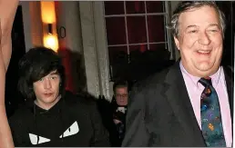  ??  ?? BIG SMILE: Stephen Fry, 61, with husband Elliott, 31. Left: Liz Hurley, 53, leaving the party in her thigh-high dress