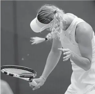  ?? Ben Curtis, The Associated Press ?? Caroline Wozniacki shakes her head to avoid the flying insects during her women's singles match against Ekaterina Makarova on Wednesday.