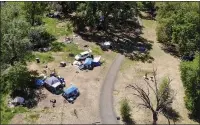  ??  ?? Tents and camps populate Comanche Creek Greenway on Sunday in Chico.