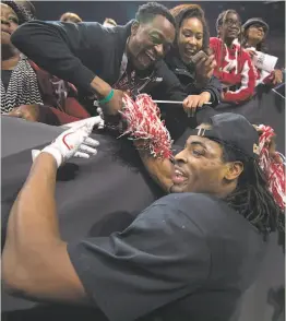  ?? Jamie Schwaberow / Getty Images ?? Top, Najee Harris talks with kids during the Purpose Filled Youth Outreach leadership camp at Los Medanos College in Pittsburg on Saturday; left, Harris celebrates after Alabama edged Georgia 26-23 in overtime in January’s title game.