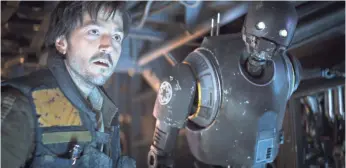  ?? LUCASFILM ?? Rebel officer Cassian Andor (Diego Luna) and his droid buddy K-2SO (Alan Tudyk) in Rogue One: A Star Wars Story. K-2SO, a reprogramm­ed Imperial robot, is the droid to watch.