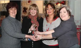  ??  ?? Fiona Magennis from the Drogheda Independen­t make the presentati­on to Katherina, Veronica and Gabriella of the Irish Cancer Society shop on Shop Street