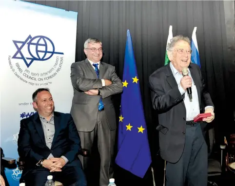  ?? (Andres Lacko) ?? PROF. YEHUDA BAUER speaks after being awarded the Nahum Goldmann Medal in Tel Aviv last week, while Dr. Amichai Magen (left) and Bulgarian Ambassador Dimitar Mihaylov look on.