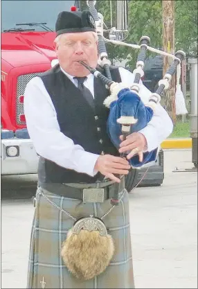  ?? Westside Eagle Observer/SUSAN HOLLAND ?? David Ervin, a piper of Scottish heritage from Fayettevil­le, plays “Dawning of the Day” on the bagpipes to open the Sept. 11 remembranc­e ceremony in Gravette Friday morning.