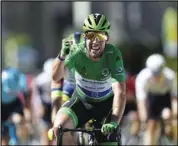  ?? Associated Press ?? TIED
Britain’s Mark Cavendish celebrates as he crosses the finish line to win the thirteenth stage of the Tour de France cycling race with start in Nimes and finish in Carcassonn­e, France on Friday.