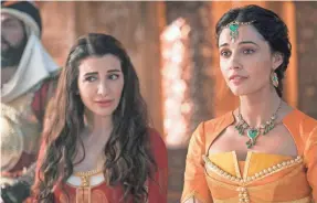  ??  ?? Princess Jasmine (Naomi Scott, right), who wants to experience life beyond her palace, has a loyal handmaid in Dalia (Nasim Pedrad).
