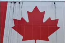  ?? MATHEW MCCARTHY, RECORD STAFF ?? Black stains are seen on the Canadian flag at Themuseum in Kitchener on Monday.