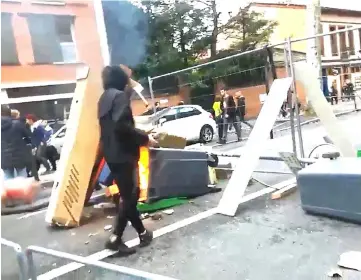  ??  ?? A man builds a barricade during the clashes with protesters wearing yellow vests, a symbol of a French drivers’ protest against higher diesel taxes, Toulouse, France in this picture obtained from a social media video. — Reuters photo