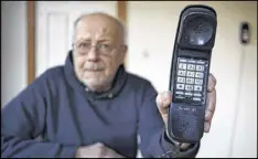  ?? ROBERT F. BUKATY / ASSOCIATED PRESS ?? Peter Froehlich holds the landline telephone he uses at his rural home in Whitefield, Maine. Froehlich is worried that he will be unplugged.