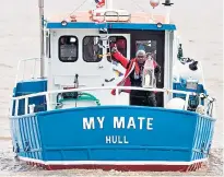  ??  ?? The Archbishop of York, Dr John Sentamu, carries a lit lantern for a five-mile trip up the Humber to Holy Trinity