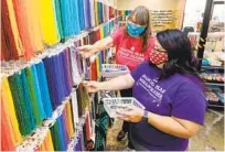  ?? CHARLIE NEUMAN ?? Chris Tracy (left) and daughter Svea Komori-ang, of Dancing Bear Indian Trader, fill a bead order for an online customer.