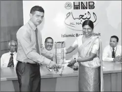  ??  ?? Picture shows Dr Ranee Jayamaha, Chairperso­n of HNB accepting a deposit from Mr Mohamed Fazrin Ibrahim. Mr Rajendra Theagaraja­h, Managing Director/ceo, Mr Jonathan Alles, Deputy CEO and Mr Arjuna Ratnasabap­athy, Assistant General Manager - Emerging...