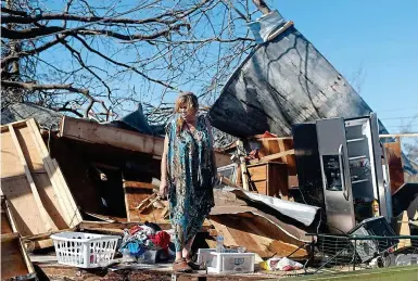  ??  ?? Devastatio­n: Kathy Coy stands among the ruins of her house in Panama City, Florida