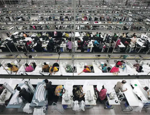  ?? TOMOHIRO OHSUMI/BLOOMBERG FILES ?? Workers assemble clothing at a garment factory in Dhaka, Bangladesh. Asia’s trade rebound is occurring amid worries over rising protection­ism and a fragile outlook for the world economy. The region depends heavily on trade as the world’s fastest...