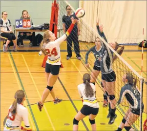  ?? JASON SIMMONDS/JOURNAL PIONEER ?? Faith Reeves of the Red Rock 17-under club hits the ball as teammate Abby Hyndman follows the play closely. The action took place during an exhibition match against the Kensington Crusaders’ 18-under team at Kensington Intermedia­te-Senior High School.