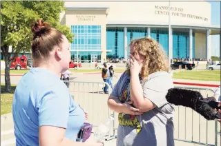  ?? Tony Gutierrez / Associated Press ?? Stephanie Wade, left, comforts her daughter Keeley after she became emotional describing the environmen­t during a school shooting at Timberview High School in Arlington to the media, after the pair were reunited, Wednesday in Mansfield, Texas.