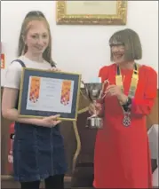  ?? ?? Emily Bennie receives her Young Musician of the Year 2021 Award from Rotary Club of Campbeltow­n president Pat Healey.