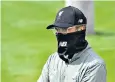  ??  ?? Masked man: Manager Jurgen Klopp