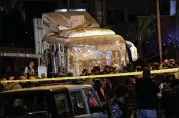  ?? NARIMAN EL-MOFTY / AP ?? Security forces stand near a bus after a roadside bomb exploded in an area near the Giza Pyramids on Friday and killed three tourists and their guide.