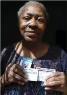  ??  ?? In this April 24 photo, Gladys Harris of Milwaukee holds some of the forms of identifica­tion she brought with her to the polls in the 2016 presidenti­al election. AP PHOTO/CARRIE ANTLFINGER