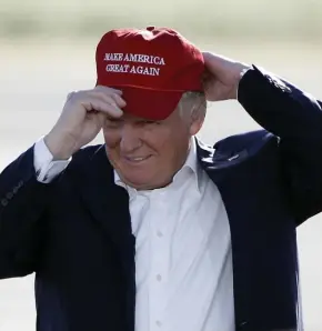  ?? AP FILE ?? GREAT DEBATE: President Trump dons a ‘Make America Great Again’ hat at a past rally in California. Republican pundits say Trump is more popular than ever in New Hampshire, but Democrats disagree.