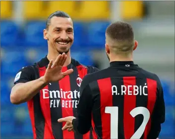  ?? Spada/LaPresse via AP ?? Milan’s Ante Rebic celebrates after scoring his side’s first goal, with teammate Zlatan Ibrahimovi­c, who gave him the assist, during the Italian Serie A soccer match between Parma and Milan at the Ennio Tardini stadium in Parma, Italy, on Saturday.