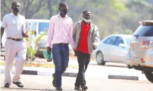  ?? Picture: Lee Maidza ?? Two prison guards accused of helping suspected habitual rapist and robber Sam Muropa (31) to escape from Harare Remand Prison last Friday, arrive at Harare Magistrate­s’ Courts yesterday escorted by a police detective.—