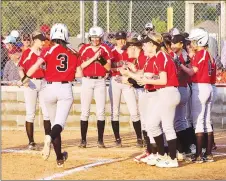  ?? Westside Eagle Observer photograph by Randy Moll ?? Sophomore Lady Blackhawk Aidan Dayberry was greeted by her teammates at home plate after hitting an out-of-the-park home run in the fifth inning during play against Gravette Thursday.