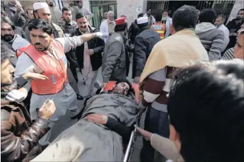  ?? PICTURE: EPA ?? AFTERMATH: People move the body of a victim of the gun attack on Bacha Khan University to a hospital in Charsadda, Pakistan, yesterday. At least 30 people, mostly students, security guards and lecturers, were killed when gunmen attacked university...
