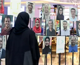  ?? Photo by Dhes Handumon ?? A visitor views the photo gallery of top students of the One Million Arab Coders Initiative during an event held in Dubai on Monday to honour them. —