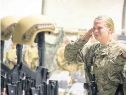  ?? AP ?? In this December 23, 2015 file photo, a US service member salutes her fallen comrades during a memorial ceremony for six Airmen killed in a suicide attack, at Bagram Air Field, Afghanista­n.
