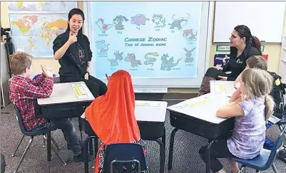  ?? PHOTOS PROVIDED TO CHINA DAILY ?? Zheng Xuan teaches Chinese Sign Language at the Metro Deaf School in Saint Paul, Minnesota, the United States.