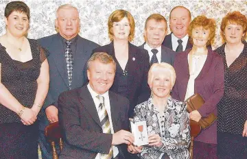  ??  ?? Pride Alex with his family after being awarded an MBE for services to football Advice Alex has some wise words for a young Kenny Miller while on Scotland duty