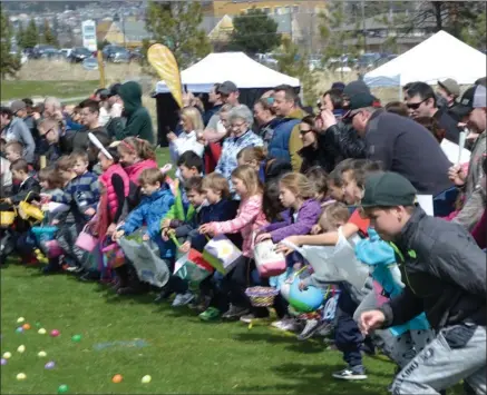  ?? RON SEYMOUR/The Daily Courier ?? It was every youngster for themselves once the horn blew to start the hunt for treats at 1 p.m.The event raised more than $6,000 for the Kelowna and West Kelowna food banks.