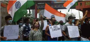  ?? —AFP ?? KOLKATA: Indian citizens of Chinese origin holding placards and Indian flags shout slogans in support of the Indian army during an anti-China demonstrat­ion in Kolkata’s Chinatown on Saturday.