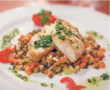  ??  ?? Roasted swordfish served with French lentils and citrus chimichurr­i will be one of the entrees on Dinner for Two’s Valentine’s Day menu.