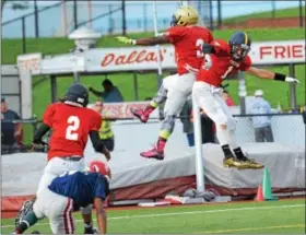  ??  ?? Team Freedom’s Kori Smith (3) and Jared Johns-Lupold (1) celebrate after Smith hauled in a touchdown pass from quarterbac­k Matt Duff in the fist half of Freedom’s 42-18 victory over Team American.