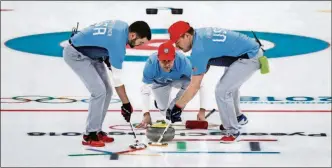  ?? [PHOTOS BY AARON FAVILA/THE ASSOCIATED PRESS] ?? United States skip John Shuster (center) launches the stone during a men’s curling semifinal match against Canada at the Winter Olympics Thursday in Gangneung, South Korea. The United States won.