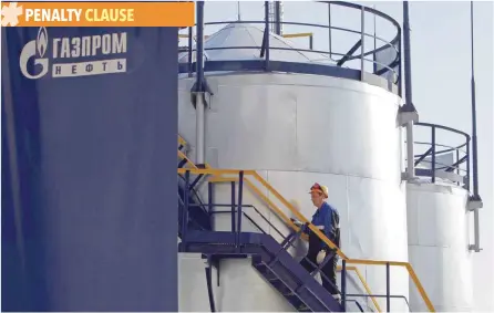  ?? — Reuters ?? An employee walks up the stairs at the Gazprom Neft oil refinery in Moscow, Russia.