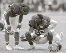  ?? Brett Coomer / Houston Chronicle ?? Texans running back Lamar Miller, left, checks on Alfred Blue, who suffered a high-ankle sprain during a joint practice with the Saints this week. His return date is uncertain.