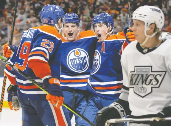  ?? CODIE MCLACHLAN/GETTY IMAGES ?? From left: Oilers forwards Leon Draisaitl, Zach Hyman and Ryan Nugent-Hopkins celebrate a goal against the Los Angeles Kings in Game 1 of their first-round playoff series at Rogers Place on Monday. The Oilers won 7-4, their first Game 1 series win in six tries.