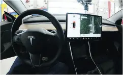  ?? JOHN SHISHMANIA­N / THE NORWICH BULLETIN VIA THE ASSOCIATED PRESS ?? The dashboard interior of the semi-autonomous 2018 Tesla Model 3 at the Consumer Reports Auto Test Track.