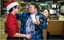  ?? STEVE SCHAEFER / SPECIAL TO THE AJC ?? Kim Cheek (right) hugs Jerry Hatcher at Children’s Healthcare of Atlanta at Scottish Rite Hospital after he bought her breakfast, a Christmas Eve tradition for him.