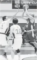  ??  ?? PNP’s Edmund Gonzales tries to shoot against DPWH Sec. Mark Villar of Malacañang as Presidenti­al Management Staff Sec. Bong Go looks on during their UNTV Cup game.