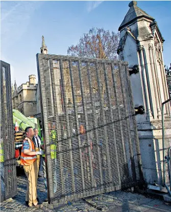  ??  ?? High security Carriage Gates, through which Westminste­r terrorist Adrian Ajao was able to access parliament­ary grounds and murder Pc Keith Palmer, were dismantled yesterday. In their place, a set made of square metal tubing and covered in wire mesh was installed.