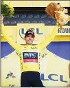  ?? (AFP) ?? Belgium’s Greg Van Avermaet, wearing the overall leader’s yellow jersey, celebrates on the podium after the ninth stage of the 105th edition of the Tour de France cycling race between Arras and Roubaix, northern France, on July 15.